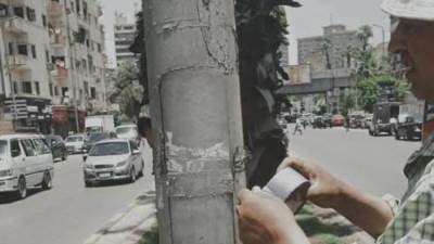 صيانة لأعمدة الإنارة وتأمين الكابلات بشارع باسيلى بالعمرانية